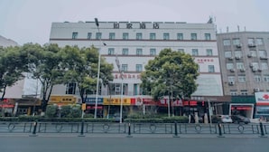 A multi-story building with a sign reading "Hotel". - Homeinn (Yangzhou)