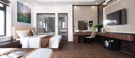 A modern hotel room with two beds, a desk, a TV, and a large window.