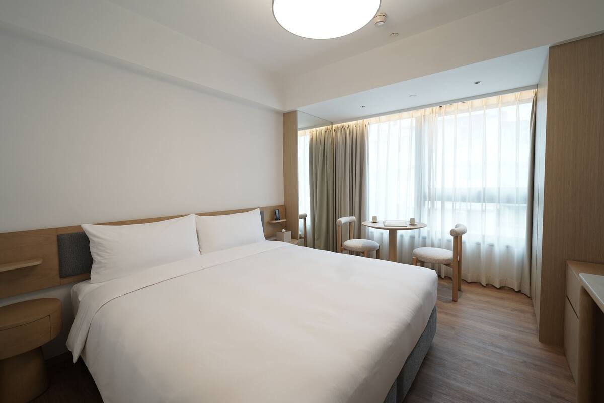 غرفة ديلوكس مزدوجة - منظر للمدينة | ألحفة محشوة بالريش وخزنة داخل الغرفة ومكتب ومساحة عمل للكمبيوتر المحمول