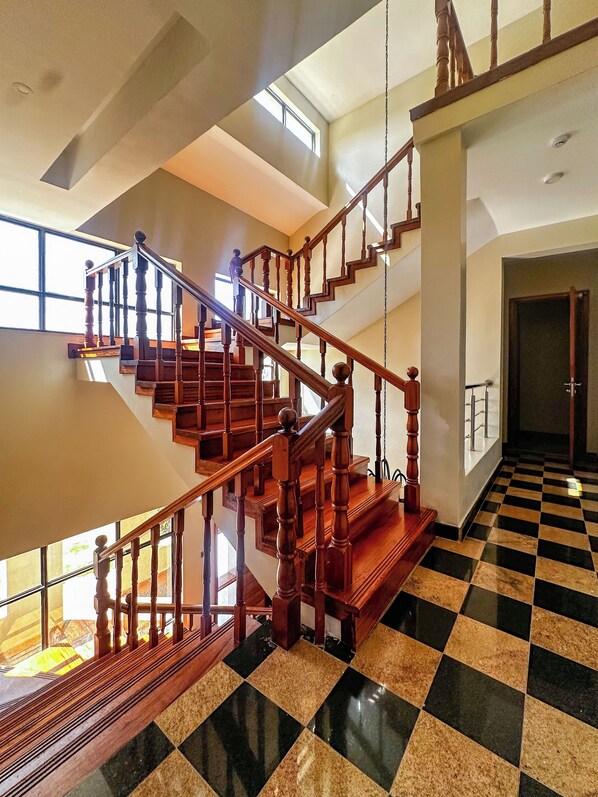 A multi-level wooden staircase with a checkered floor pattern.