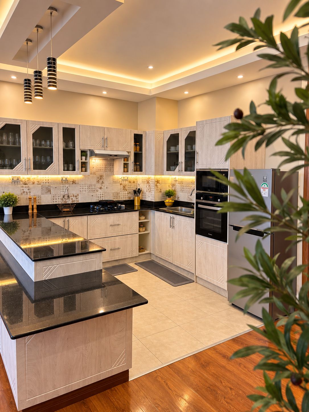 A modern kitchen with a central island, built-in appliances, and a wooden floor.