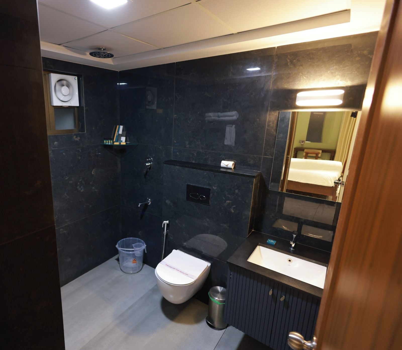 A modern bathroom with a toilet, sink, and shower.