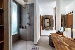 A modern bathroom with a glass-enclosed shower, a wooden vanity, and a mirror. - Villa Maya Bay by BaliSuperHost (Bali)