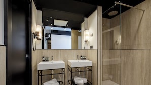 A modern bathroom with two sinks, a glass shower enclosure, and a large mirror. - The Fourth Dimension by Domidea (Rome)
