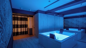 A modern bathroom with a large bathtub, wooden paneling, and a patterned wall. - The Fourth Dimension by Domidea (Rome)