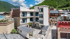 A modern multi-story building with balconies, large windows, and a flat roof. - Yemuqingshan  (Ngawa Autonomous Prefecture)