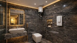 A modern bathroom with a marble sink, a toilet, a shower, and a towel rack. - Hotel Nova Inn Near Delhi Airport (New Delhi)