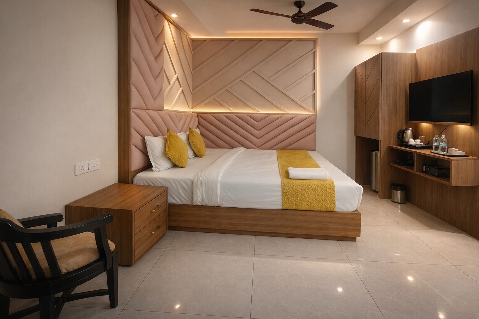A modern bedroom with a bed, bedside table, chair, TV, and built-in storage.
