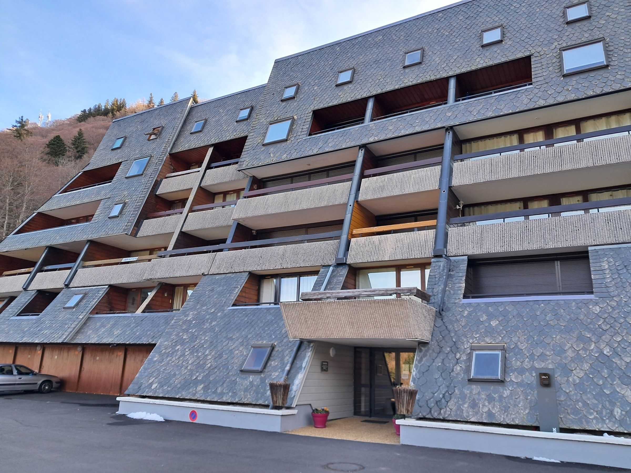 A multi-story building with a unique architectural design featuring a series of balconies and terraces.