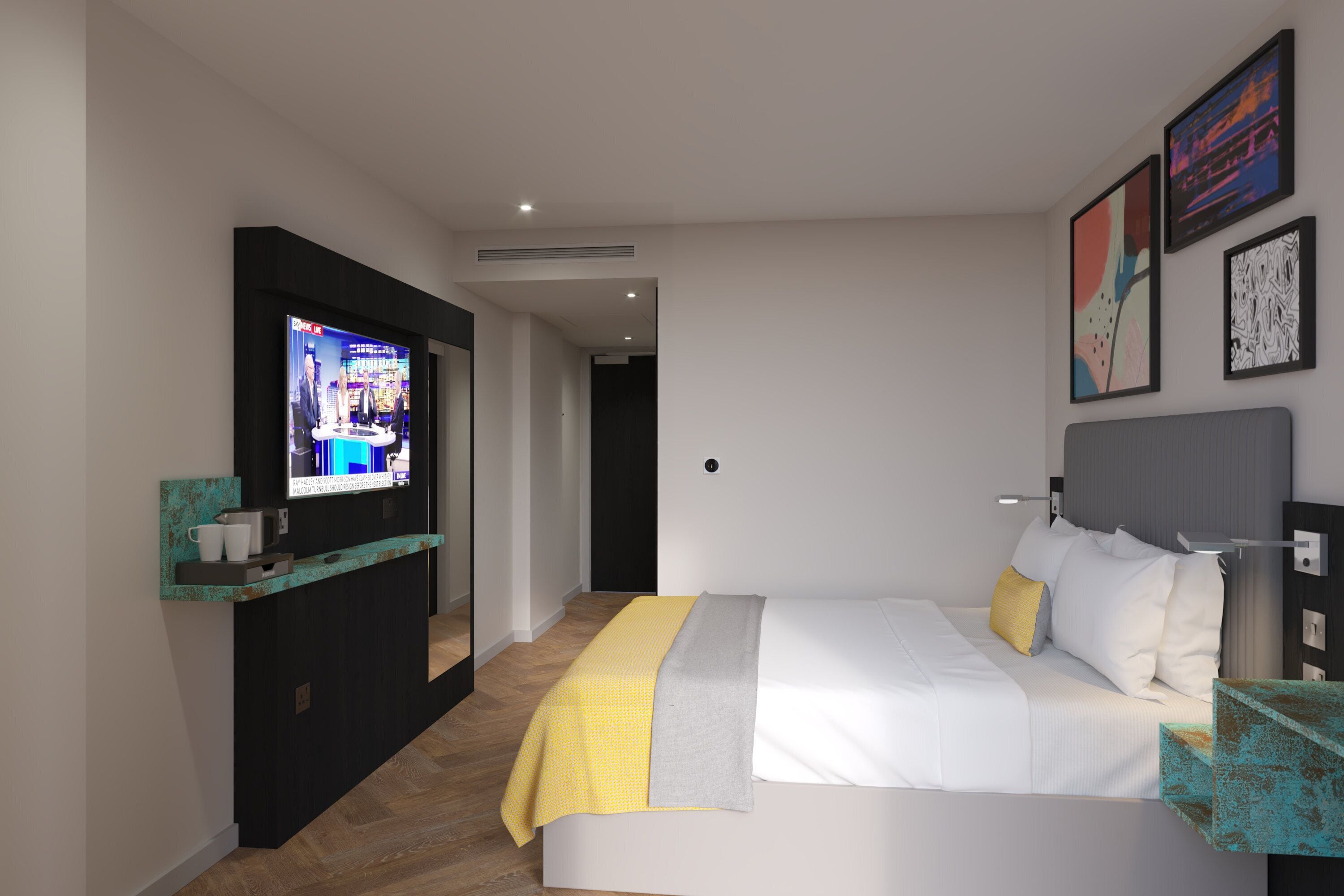 A modern hotel room with a bed, a television, and artwork on the walls.