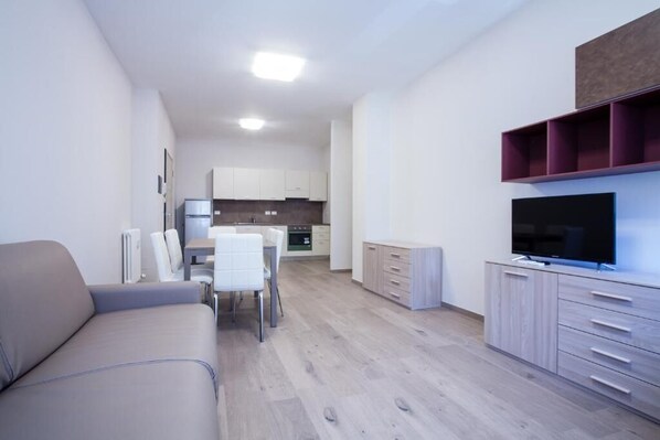 Suite Bilocale 2 persone | Living area | Flat-screen TV