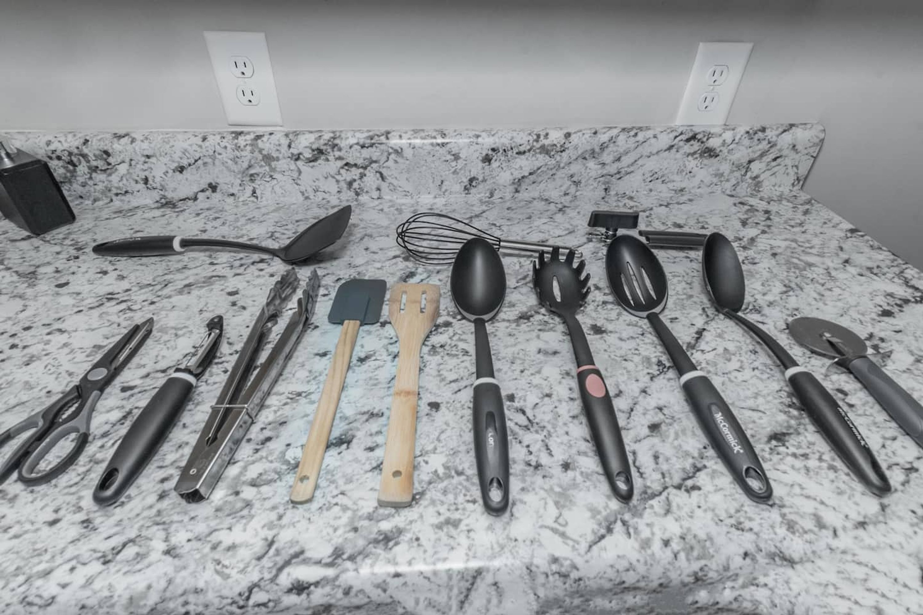 A kitchen counter with various utensils and appliances.