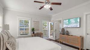 A bedroom with a bed, a ceiling fan, a television, a desk, and a window with blinds. - Walk to the Community Pool! 4 Bikes & Golf Cart! Book Today! - Shoreline at Highland Parks (Santa Rosa Beach)
