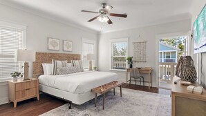 A bedroom with a bed, bedside tables, a desk, and a ceiling fan. - Walk to the Community Pool! 4 Bikes & Golf Cart! Book Today! - Shoreline at Highland Parks (Santa Rosa Beach)
