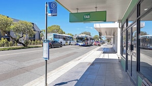 A bus stop with a shelter, a sign for Clayton Park Shops, and a bus route sign. - Metawisebnb Cozy 2bed Earlwood Near City Airport (Sydney)