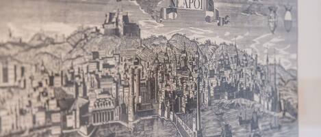 Une illustration détaillée en noir et blanc représentant un paysage urbain historique, avec des bâtiments remarquables et une rivière.