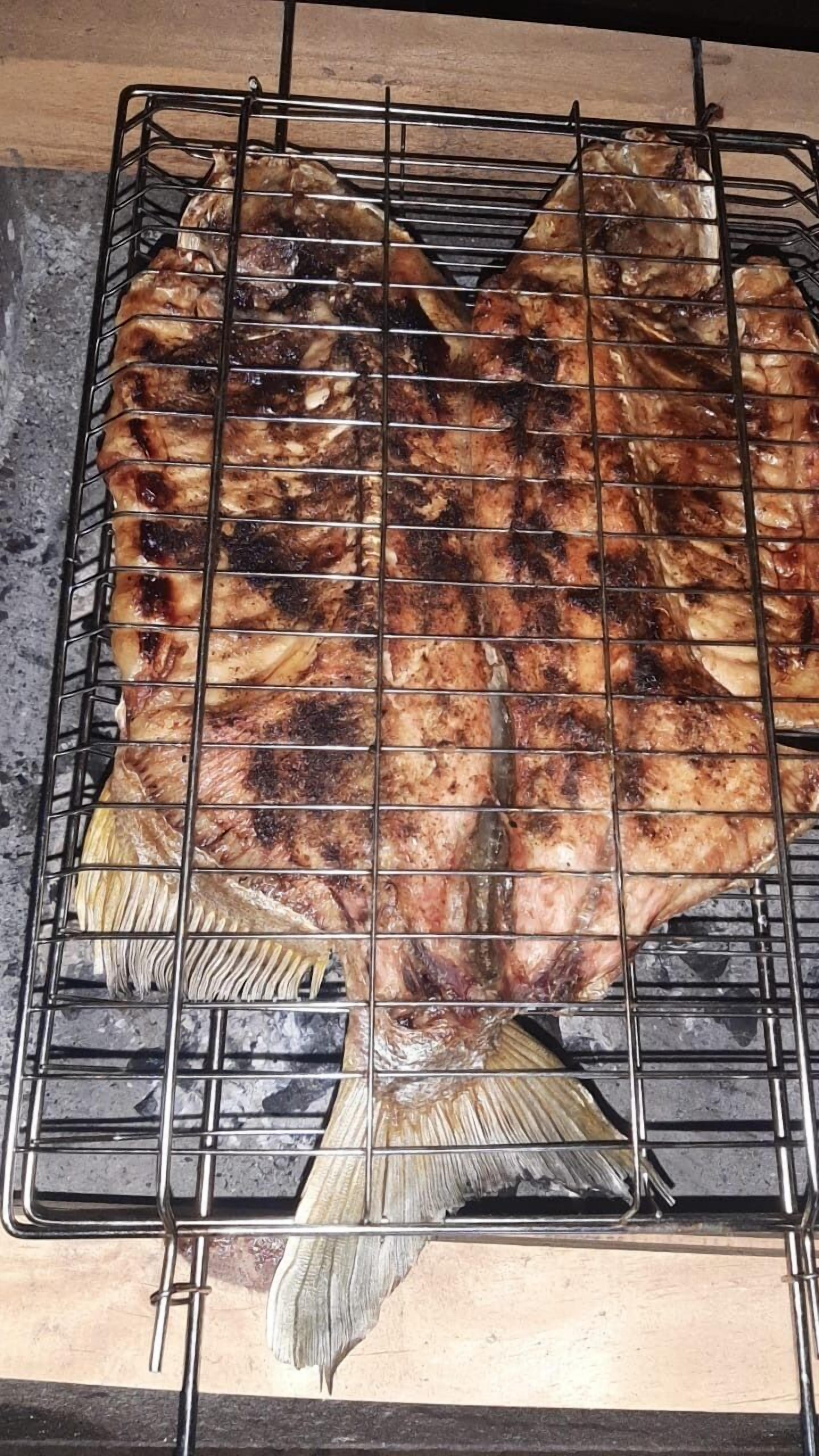 A grill with a fish on it.