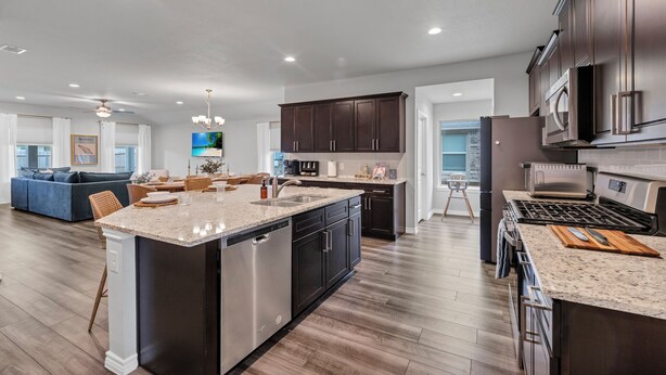 A modern kitchen with dark cabinetry, stainless steel appliances, and a large island. - Modern 4BR/2BA Home Near Airport, London HS & Local Businesses<br>Welcome to this newly built, professionally designed 4-bedroom, 2-bath home in Corpus Christi—perfect for business travelers, families, and groups of up to 8 guests. Enjoy a bright ope (Corpus Christi)