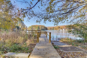 A wooden boardwalk leading to a lake with autumn foliage. - 10 Mi to Gsmnp: Scenic Lake in the Sky Retreat! (Tallassee)