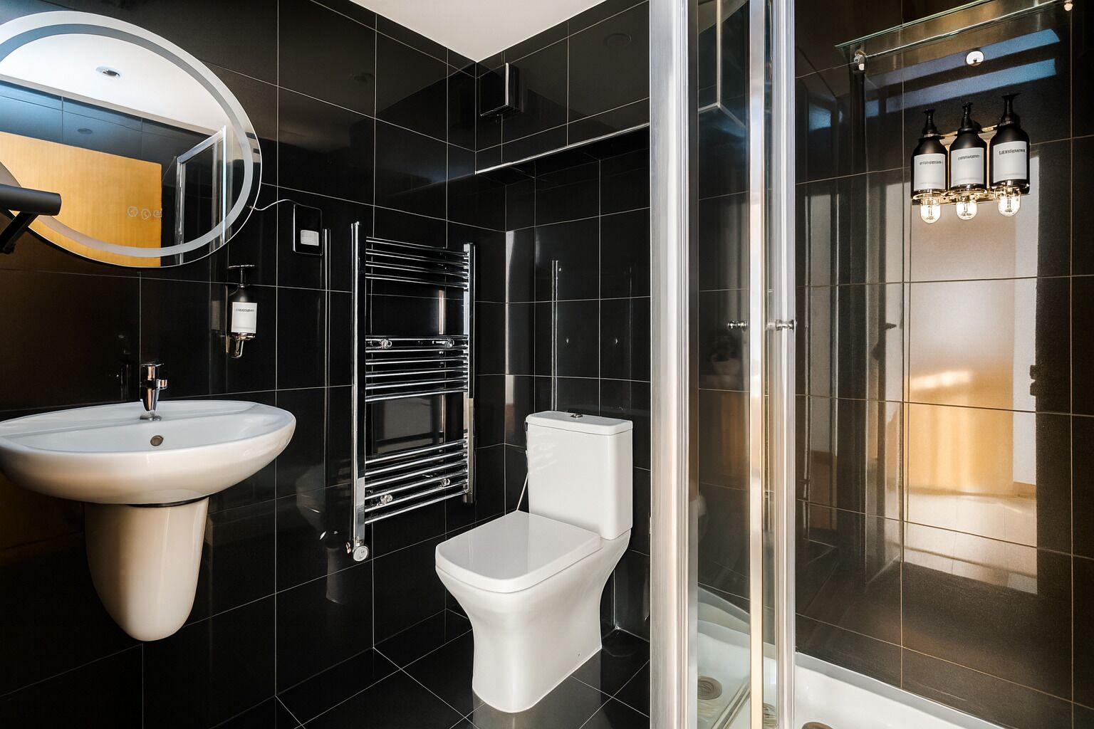 A modern bathroom with a white sink, chrome towel rack, and a toilet.