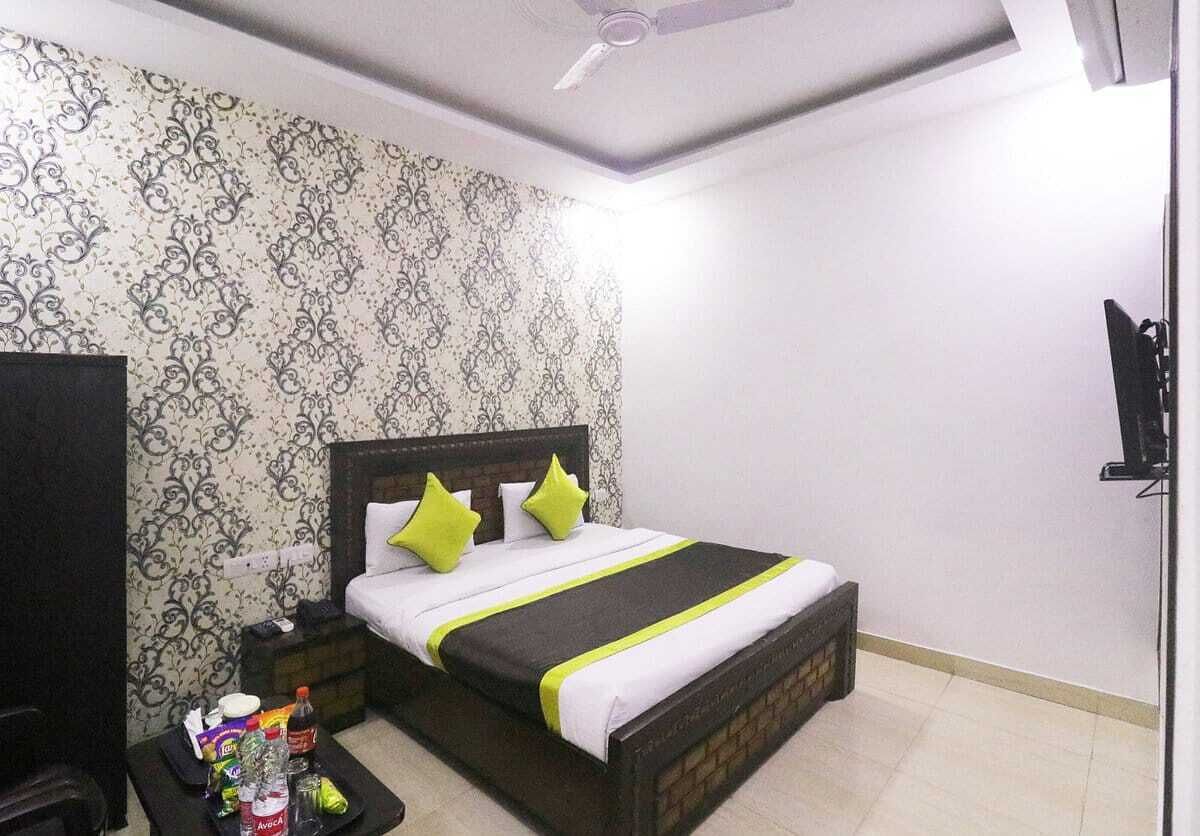 A neatly arranged bedroom with a bed, bedside table, and a small table with items on it.