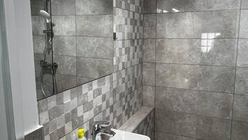 Shower, hair dryer, towels, toilet paper