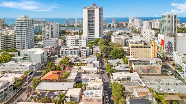A cityscape with a prominent high-rise building, various mid-rise buildings, and a mix of residential and commercial structures. - Bright, Centric and Cozy Studio In The Heart of Miramar (San Juan)