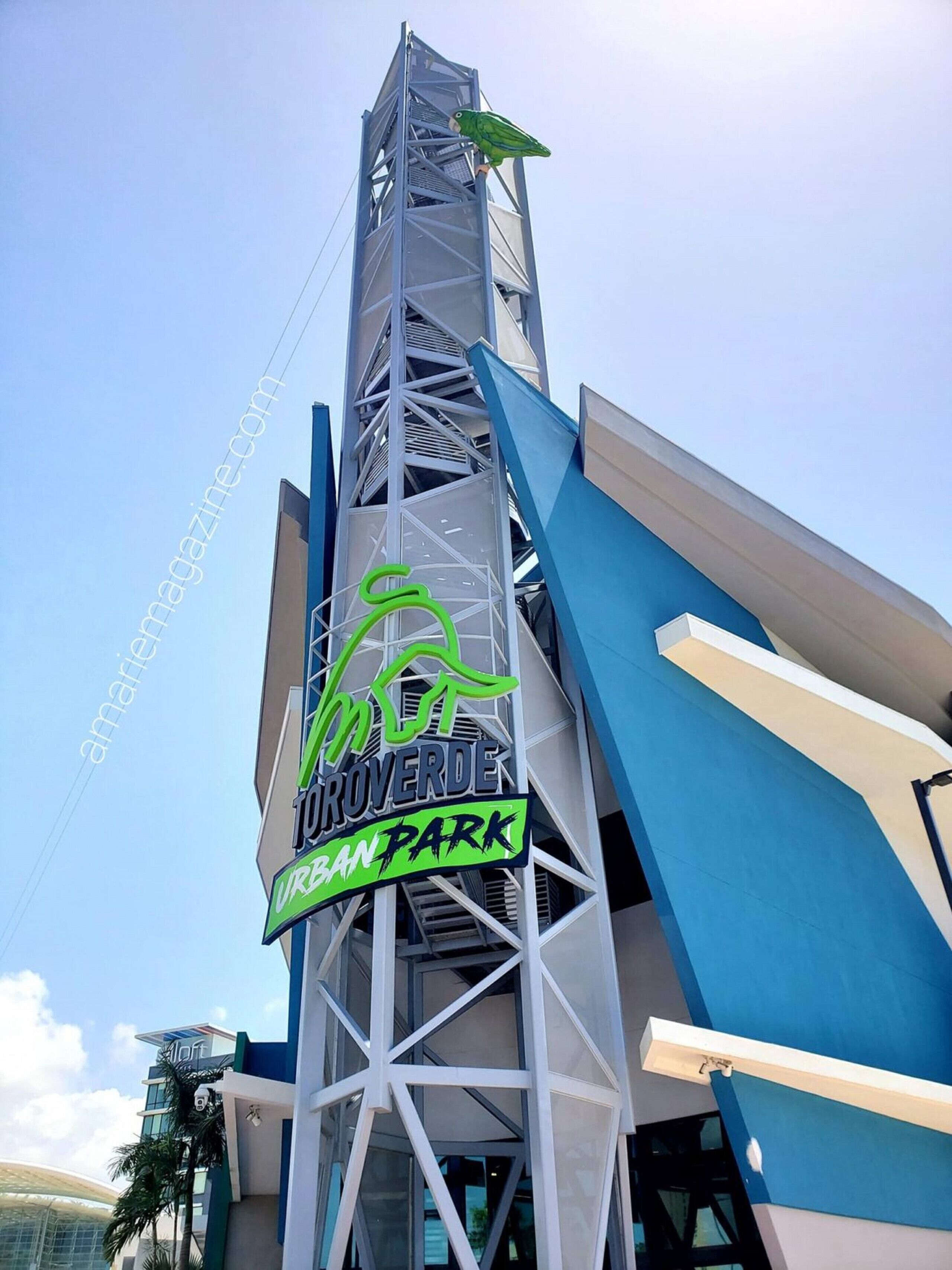 A tall building with a sign for "Iroverde Urban Park".