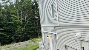 A two-story house with a small front yard and a paved driveway. - New Lux 2BR Bright & Spacious Walk-Out Suite in Halifax (Halifax)