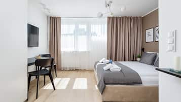 Desk, laptop workspace, blackout drapes, iron/ironing board