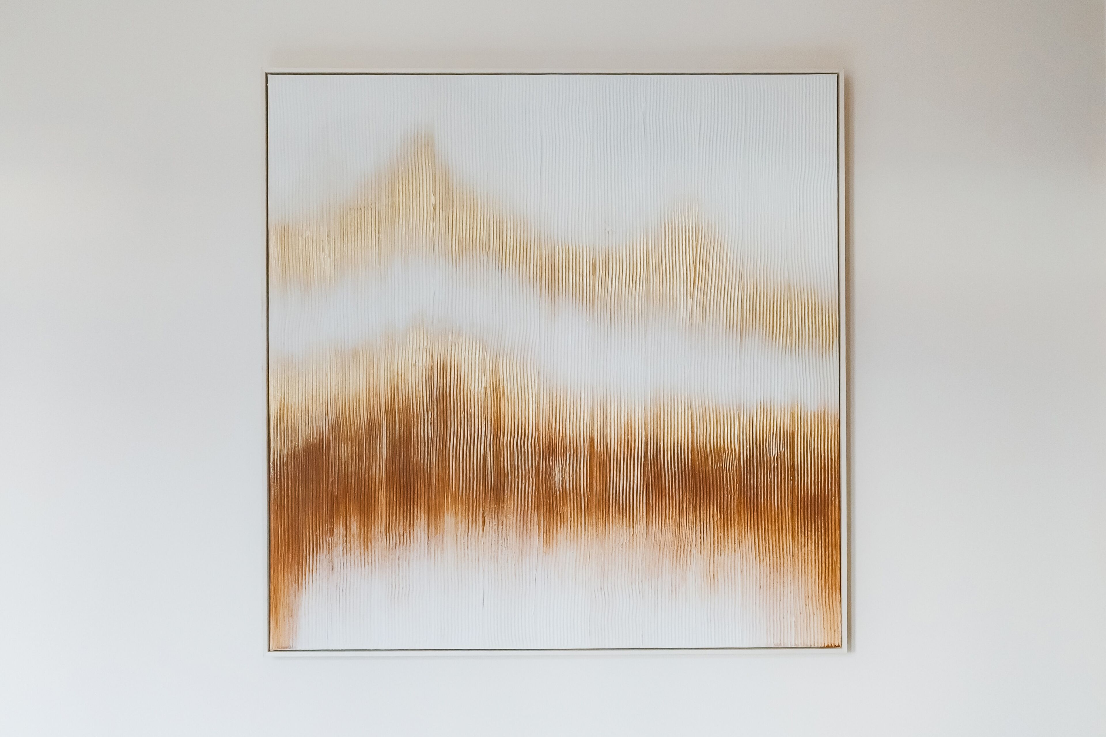 A minimalist artwork on a plain wall.