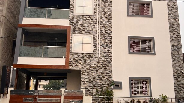 A multi-story building with a stone facade and balconies.