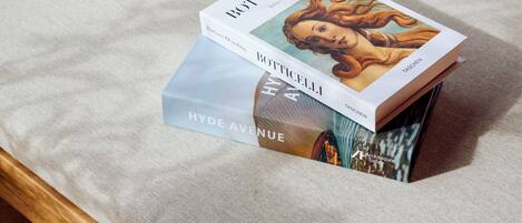 A chair with a cushion and a book titled "Botticelli" on it.