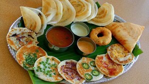 A variety of South Indian dishes on a silver platter with chutneys and sambar. - Nilgiris Inn (Kotagiri)