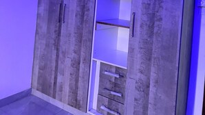 A wardrobe with multiple compartments and a mirror. - 3BR High-Rise Apartment • Prime Location 12th floor (Mombasa)