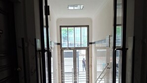An interior corridor with a glass door leading to an outdoor area. - Metro Angel Apartment 2 - 4 guests (Prague)