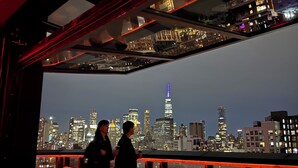 A rooftop bar with a city skyline view, featuring modern furniture and a glass ceiling. - The Merchant Hotel Lower East Side (New York)
