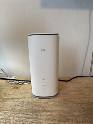 A ZTE device on a wooden surface with a white wall in the background. - Domus Philippou Tsimiski II, center of Thessaloniki (Thessaloniki)