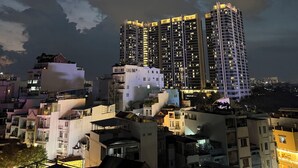A high-rise building with multiple floors, surrounded by other residential buildings.