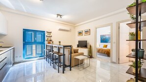 A modern apartment with a kitchen, dining area, living room, and a bedroom. - Palazzo Ducoss - Apt 7 - Two Bedroom One Bathroom (Valletta)