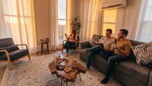 A living room with a sofa, a coffee table, and a chair.