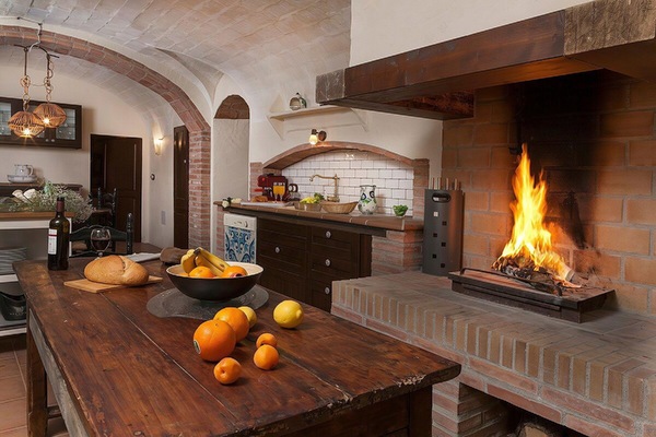 Gather around the large wooden table in the rustic kitchen, where a roaring fireplace provides a warm and inviting ambiance.