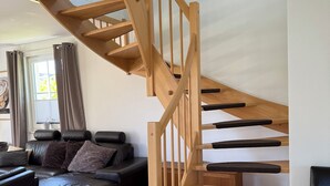 A modern living room with a wooden staircase.
