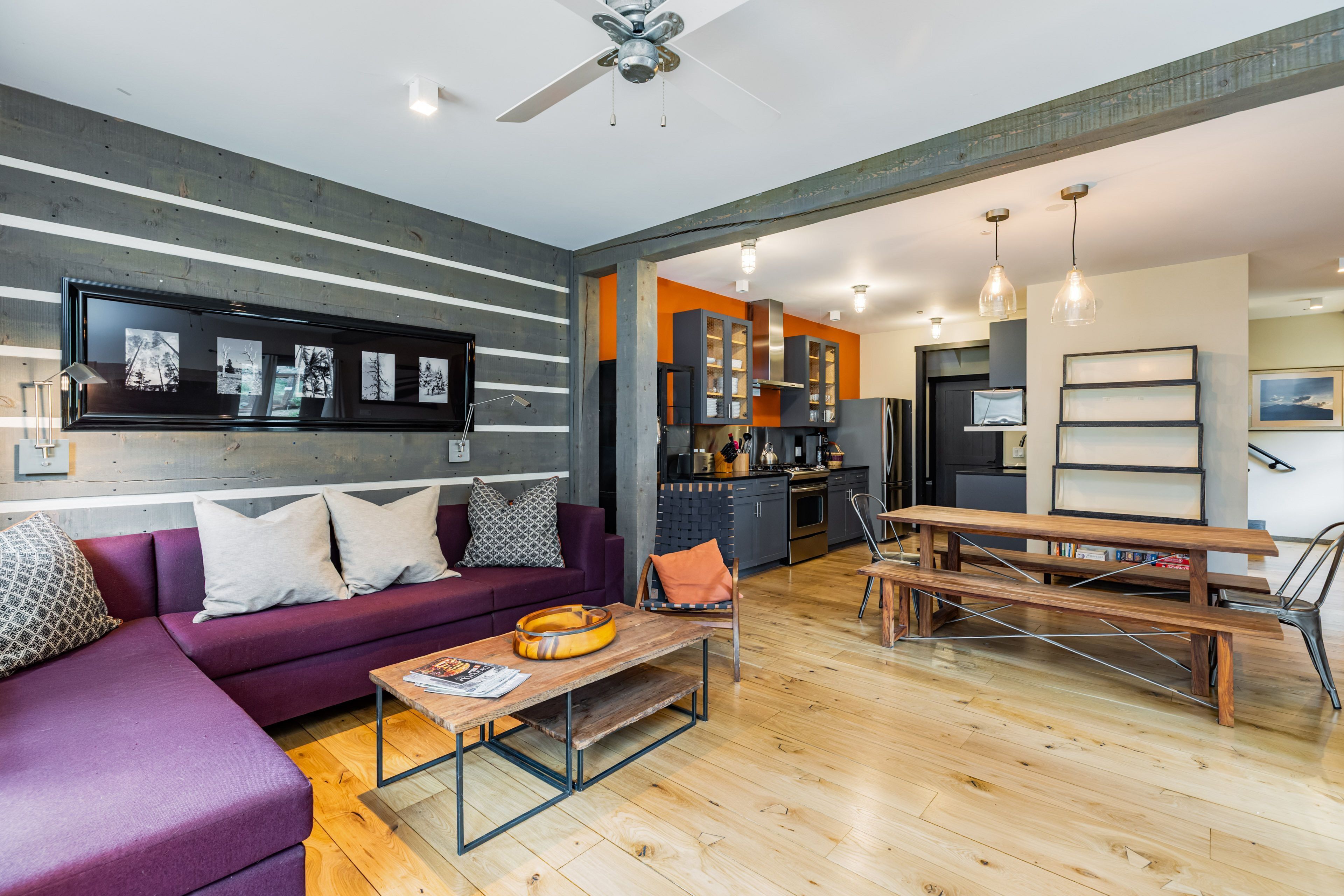A modern living room with a sofa, coffee table, and dining area.