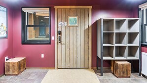 A wooden door with a small picture, a window, and a shelf unit. - Bavarian Chalet - Ski-In Ski-Out Taos Ski Valley (Taos Ski Valley)