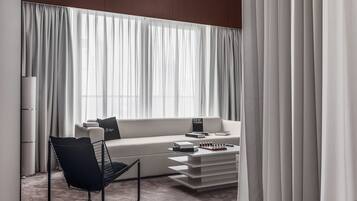 A modern living room with a sofa, a coffee table, and a chair.