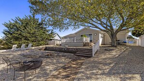 A house with a patio, outdoor seating, and a tree. - Lagoonfront Home in Beach Haven West with a pool & kayaks! (Manahawkin)