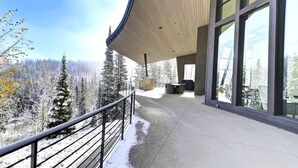 A modern building with large windows and a covered outdoor area. - The Colony at White Pine Canyon by KBM (Park City)