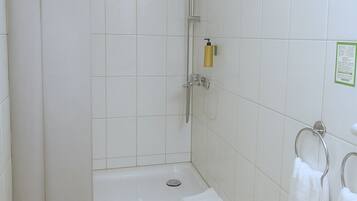 A bathroom with a shower, a sink, and a toilet.