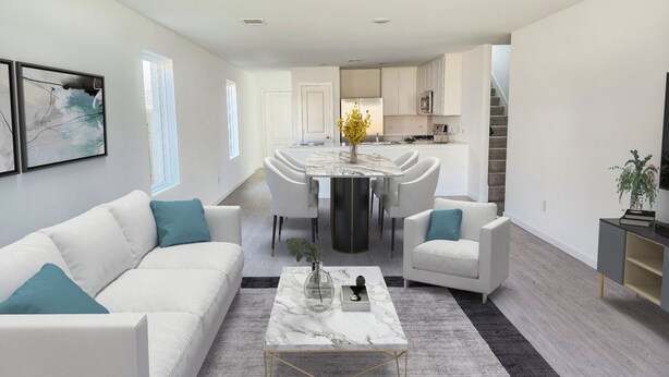 A modern living room with a white sofa, a marble coffee table, and a dining area with a central island. - Peaceful 4-bedroom house in charming Katy, Near Energy Corridor, Lagoon, parks. (Katy)